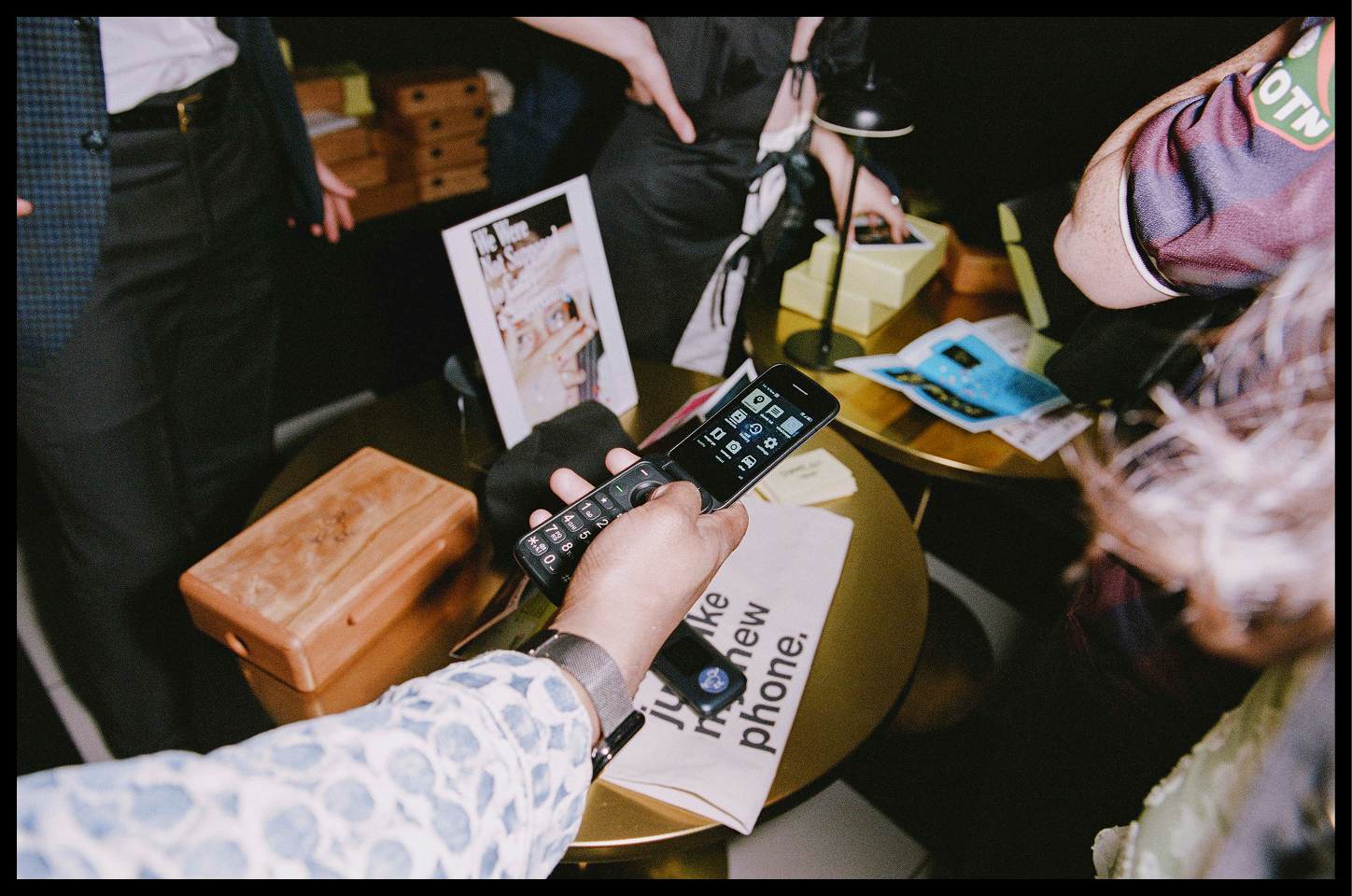 Participants gathered around a table setting up their dumbphones