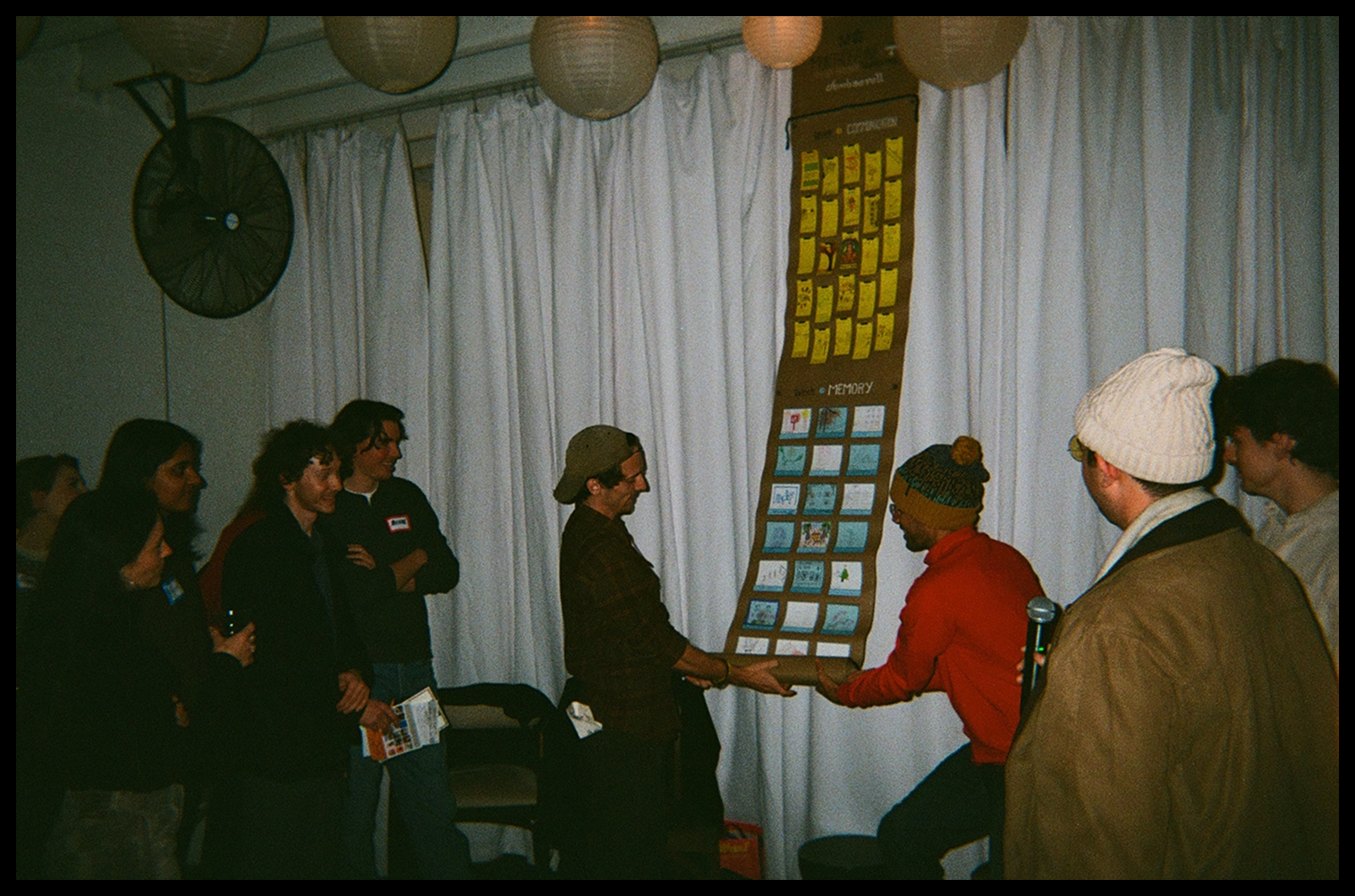 Guests viewing the dumb scroll displayed on a wall at the indoor exhibition