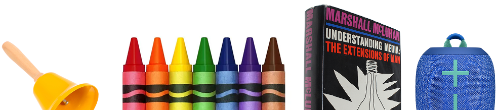 A handbell, a box of crayons, a book, and a portable speaker
